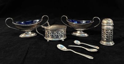 Four various silver salts with fitted blue glass liners, to include, a pair of Victorian oval twin-