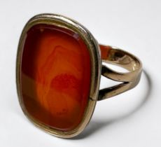 A yellow metal ring, tests as 14ct gold or above, set with a large vacant seal carnelian, gross