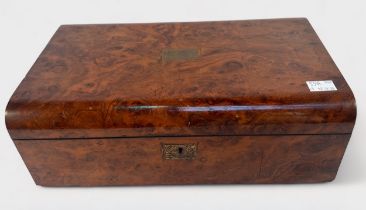 A Victorian burr walnut writing slope, the domed hinged top with brass inlay and matched flush brass