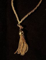 A 9ct gold necklace of woven-lace style with ball and tassle pendant 10.82g