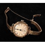 A ladies early 20th century 9ct gold cased Omega wristwatch, the silvered dial with Arabic