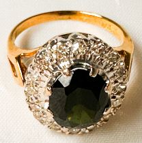 An 18ct yellow gold dress ring, set with an oval-shaped dark sapphire measuring 8mm x 6mm,