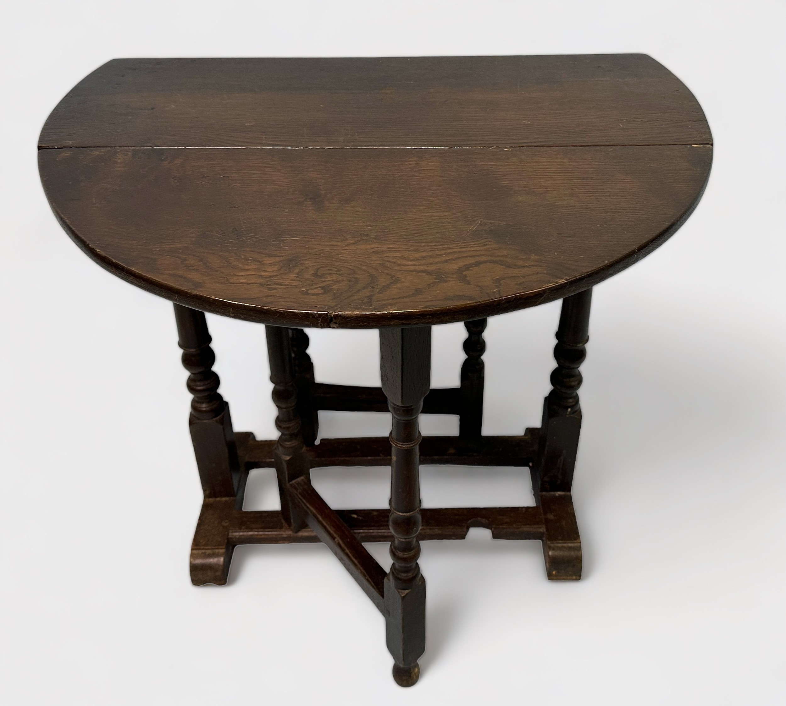 A late 19th/early 20th Century stained oak oval drop-leaf occasional table, gate-leg action base, - Image 2 of 2