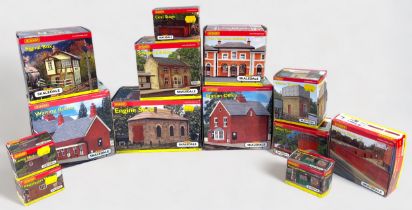 A collection of thirteen assorted boxed Hornby Skaledale model railway layout buildings,
