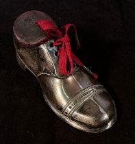 A George V silver novelty pin cushion, modelled as a laced shoe with wooden sole, by Solomon