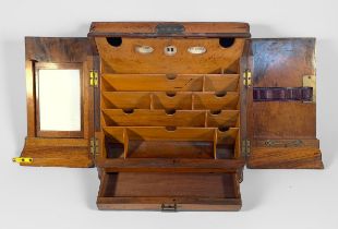 A 19th Century walnut desk tidy/writing comopendium with sloped front and two hinged doors enclosing