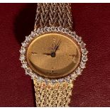 A ladies 18ct gold Omega quartz wristwatch, the oval champagne dial with applied gilt dot hour