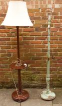 Two 20th Century solid wood floor standing standard lamps, one painted green with flora and fauna