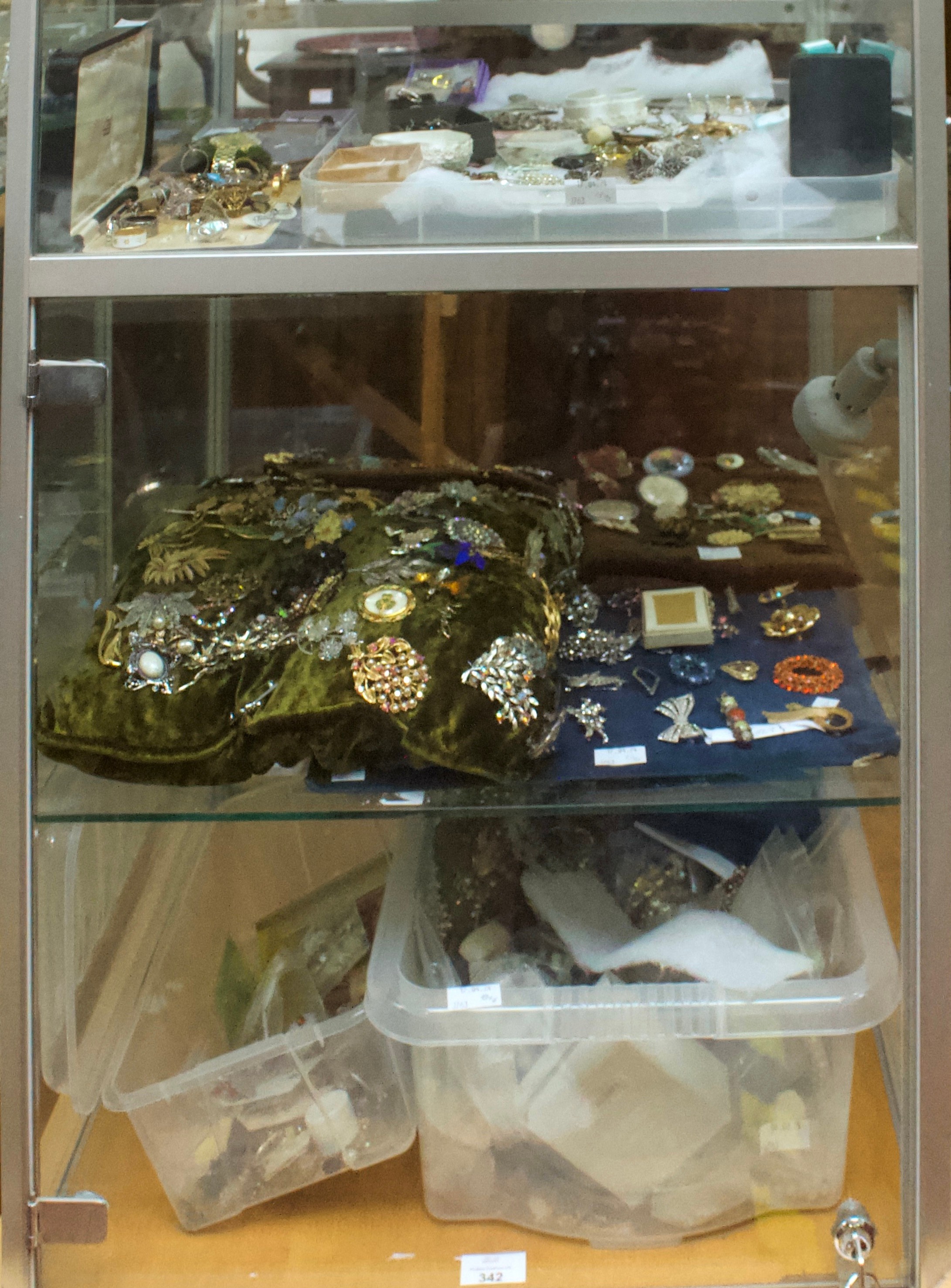 A good quantity of costume jewllery including brooches, earrings, rings, buckles etc, in two clear