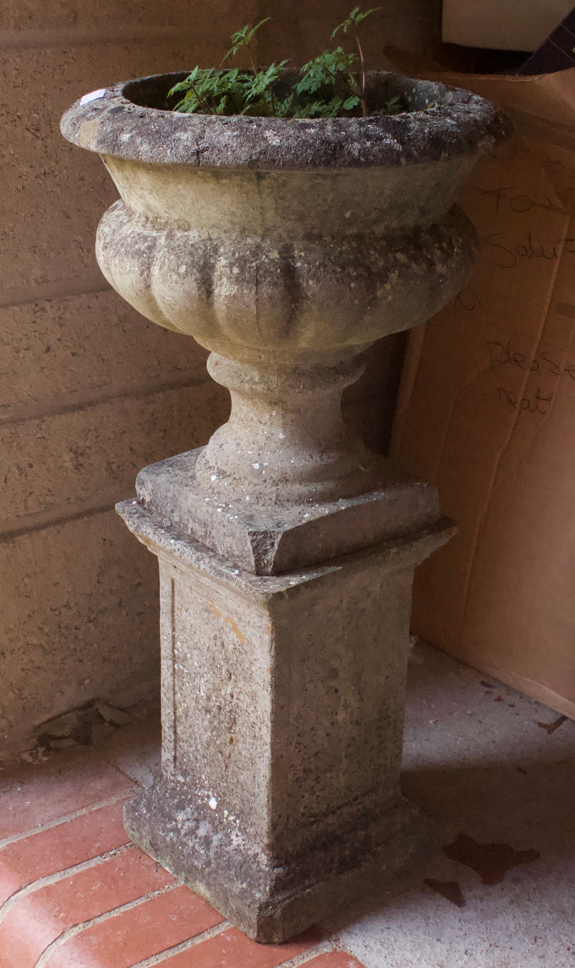 A stone garden pedestal urn, 73cm high .