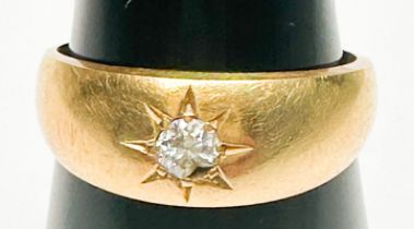 An 18ct yellow gold ring, star-set to the centre with a Victorian cut diamond (diamond chipped),