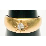 An 18ct yellow gold ring, star-set to the centre with a Victorian cut diamond (diamond chipped),