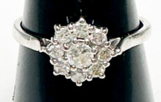 An 18ct white gold diamond ring, claw set with 9 x round brilliant cut diamonds in a daisy cluster