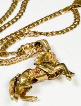 A 9ct gold curb-link chain with articulated horse pendant, total weight 27.5 grams.
