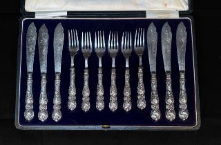 An Edwardian Silver-handled six-place dessert or fish eating set, the handles each cast with