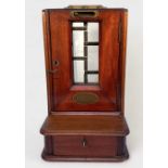 A Late 19th Century walnut Cox's Patent Till, with glass panel and sliding penny-drop, hinged door