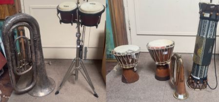 A small collection of assorted instruments, mainly percussion, including a pair of bongo drums by