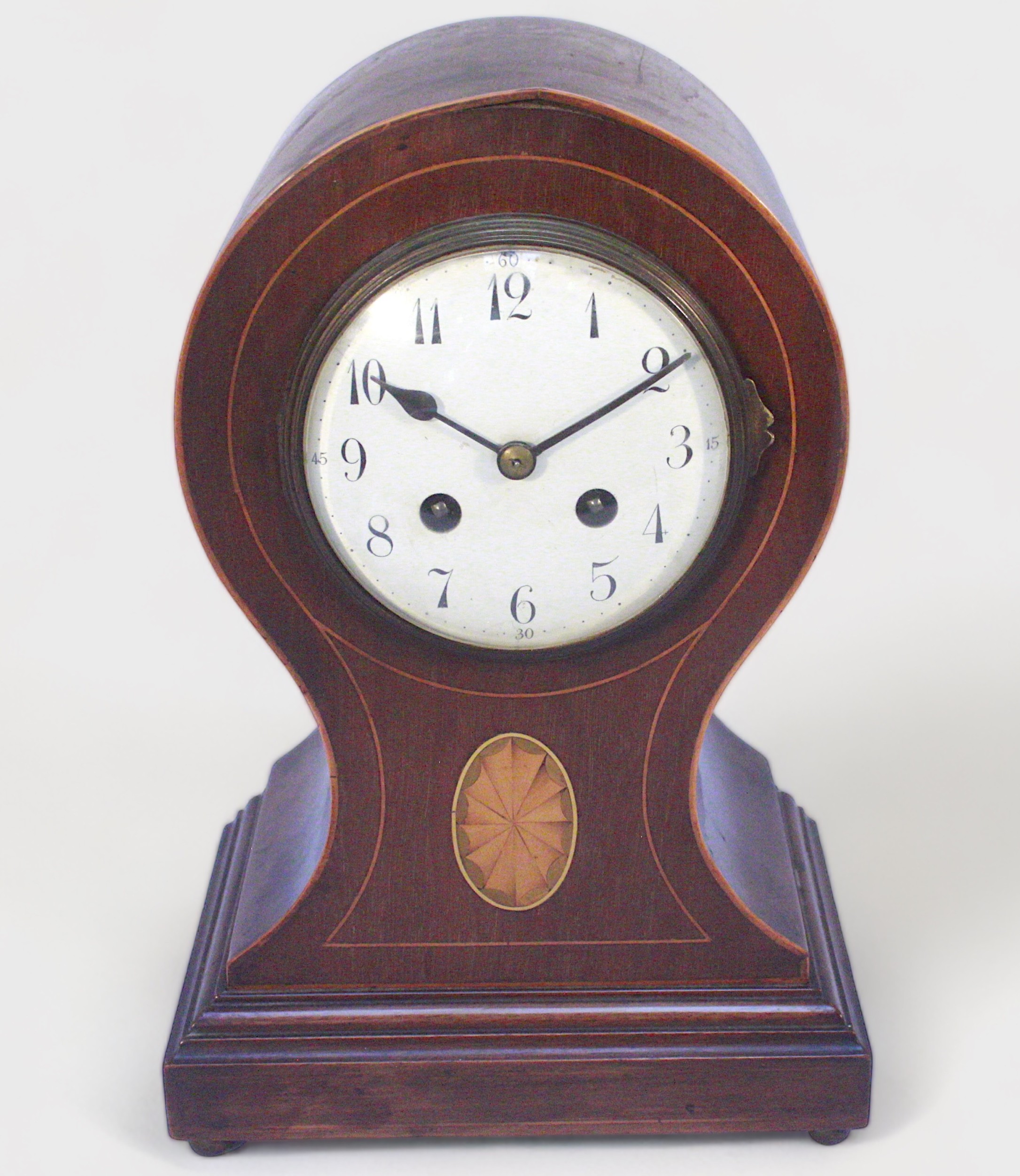 An Edwardian balloon mantel clock, with French eight-day movement by Japy Freres, striking a gong,