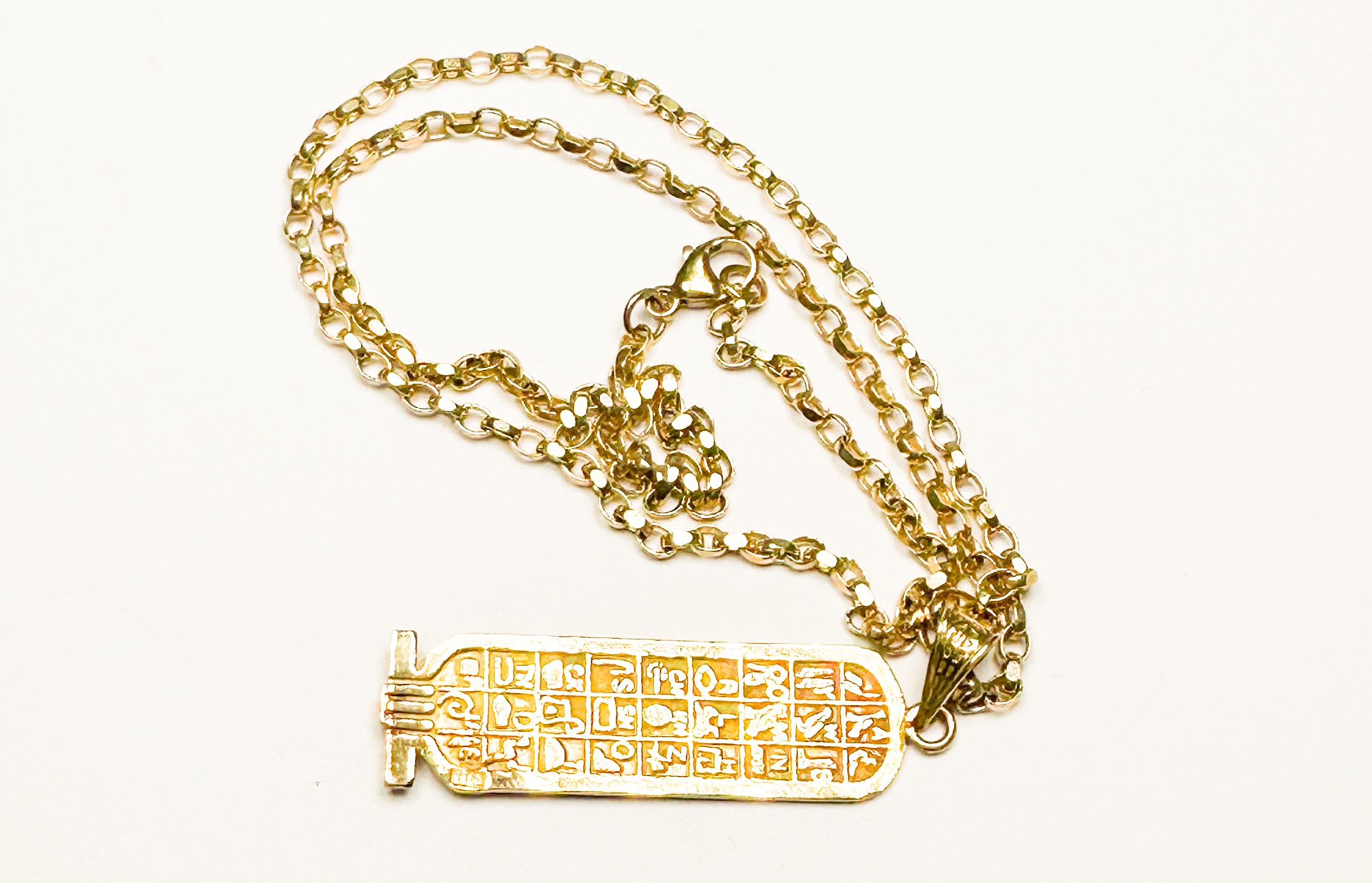 A 9ct gold hieroglyphic pendant and 9ct gold belcher chain, total weight 7.2 grams. - Image 2 of 2