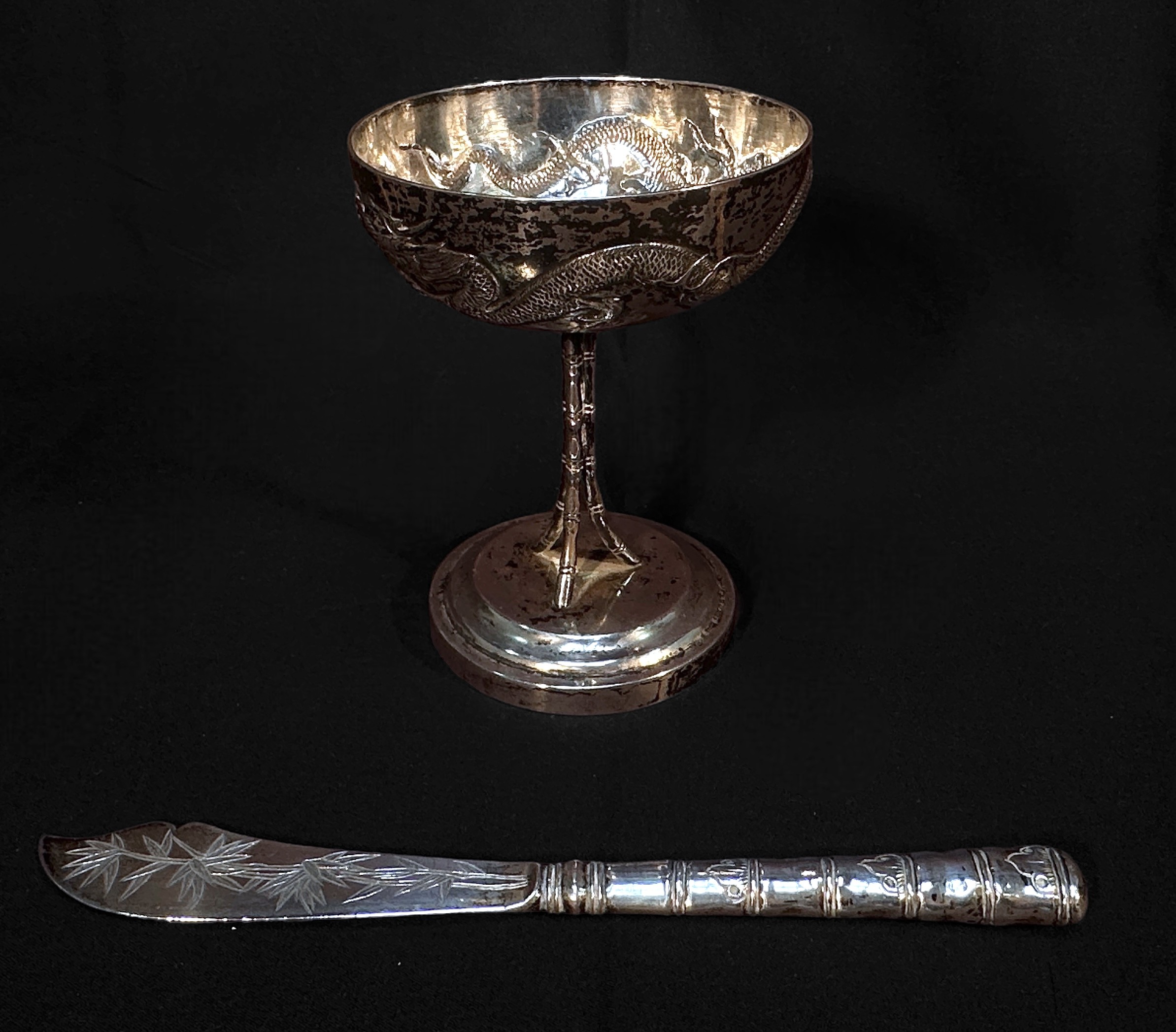 A Chinese Export Silver goblet, with shallow circular bowl embossed and chased with a dragon, the