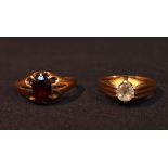 Two various signet rings, one centrally set with a white stone, the other claw set with a garnet