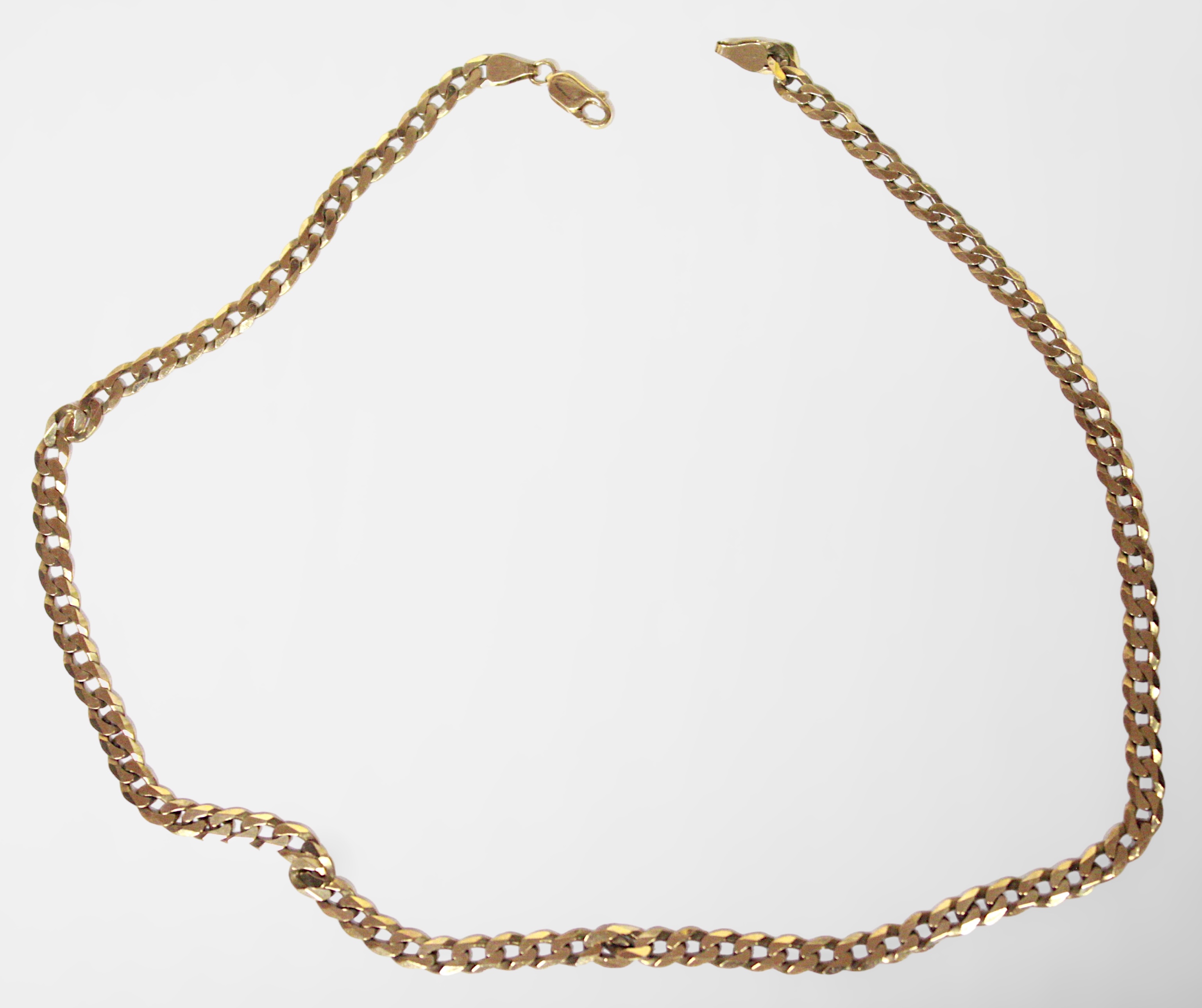 A 9ct yellow gold flat curb-link chain, hallmarked, weighs 44.7 grams, measures 24 inches.