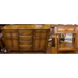 An Ercol elm Colonial sideboard, comprising four short central drawers, flanked by two cupboard