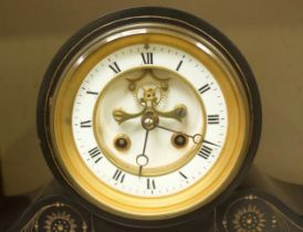 A Victorian slate striking mantel clock, the white enamel dial with Roman numerals denoting hours