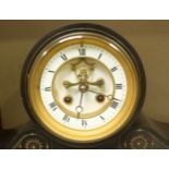 A Victorian slate striking mantel clock, the white enamel dial with Roman numerals denoting hours