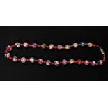 A Murano style millefiori bead necklace, interspersed with red and yellow metal beads