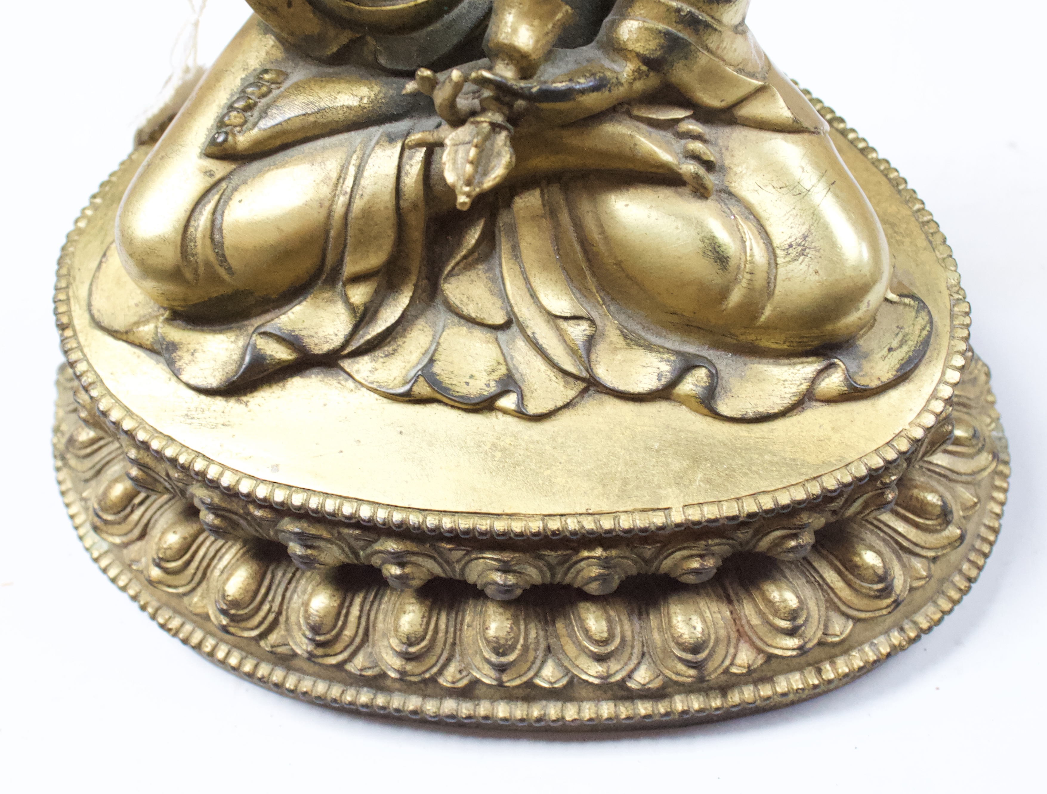 A Gilt-bronze Tibetan style Buddha, seated in lotus position and holding a vajra and meditiation - Image 6 of 14
