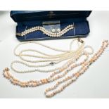 Four various cultured pearl necklaces, two with gold clasps, two with silver clasps, together with a