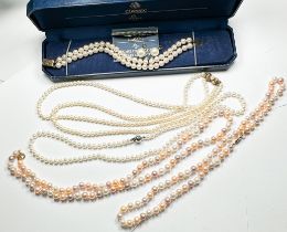 Four various cultured pearl necklaces, two with gold clasps, two with silver clasps, together with a