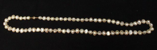 A string of cultured baroque pearls, with 14ct gold faceted spherical clasp, in Artisans of the