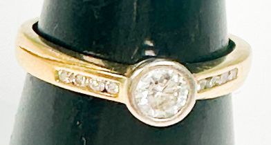 An 18ct yellow gold solitaire diamond ring, bezel-set with a round brilliant cut diamond,