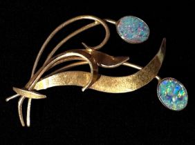 A 9ct gold spray brooch, set with two oval opals, 47mm long, gross weight approximately 5.4g