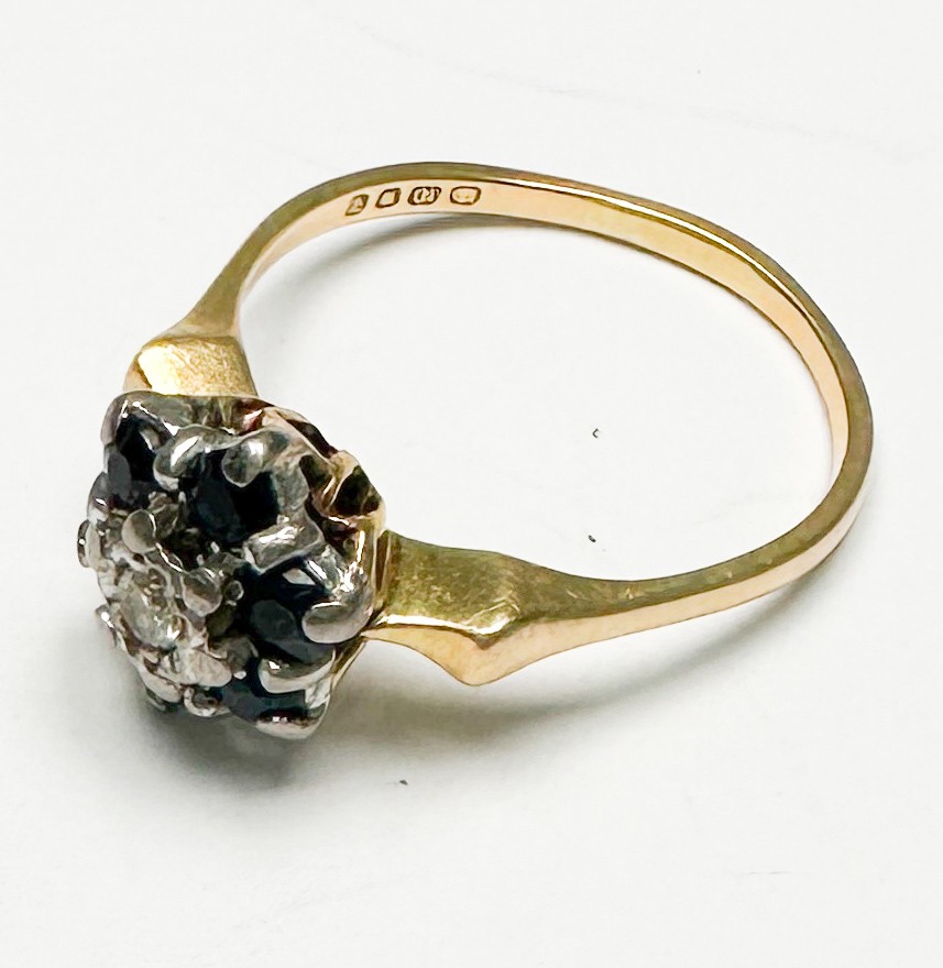 An 18ct yellow gold dress ring, claw-set with a round diamond to the centre, surrounded by 6 x