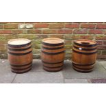 Three small coopered barrels, 40cm tall, together with two Royal Norfolk ceramic drum barrels for