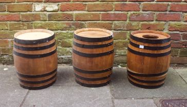 Three small coopered barrels, 40cm tall, together with two Royal Norfolk ceramic drum barrels for