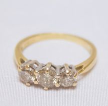 An 18ct yellow gold and three-stone diamond ring, claw-set three graduated RBC diamonds, estimated