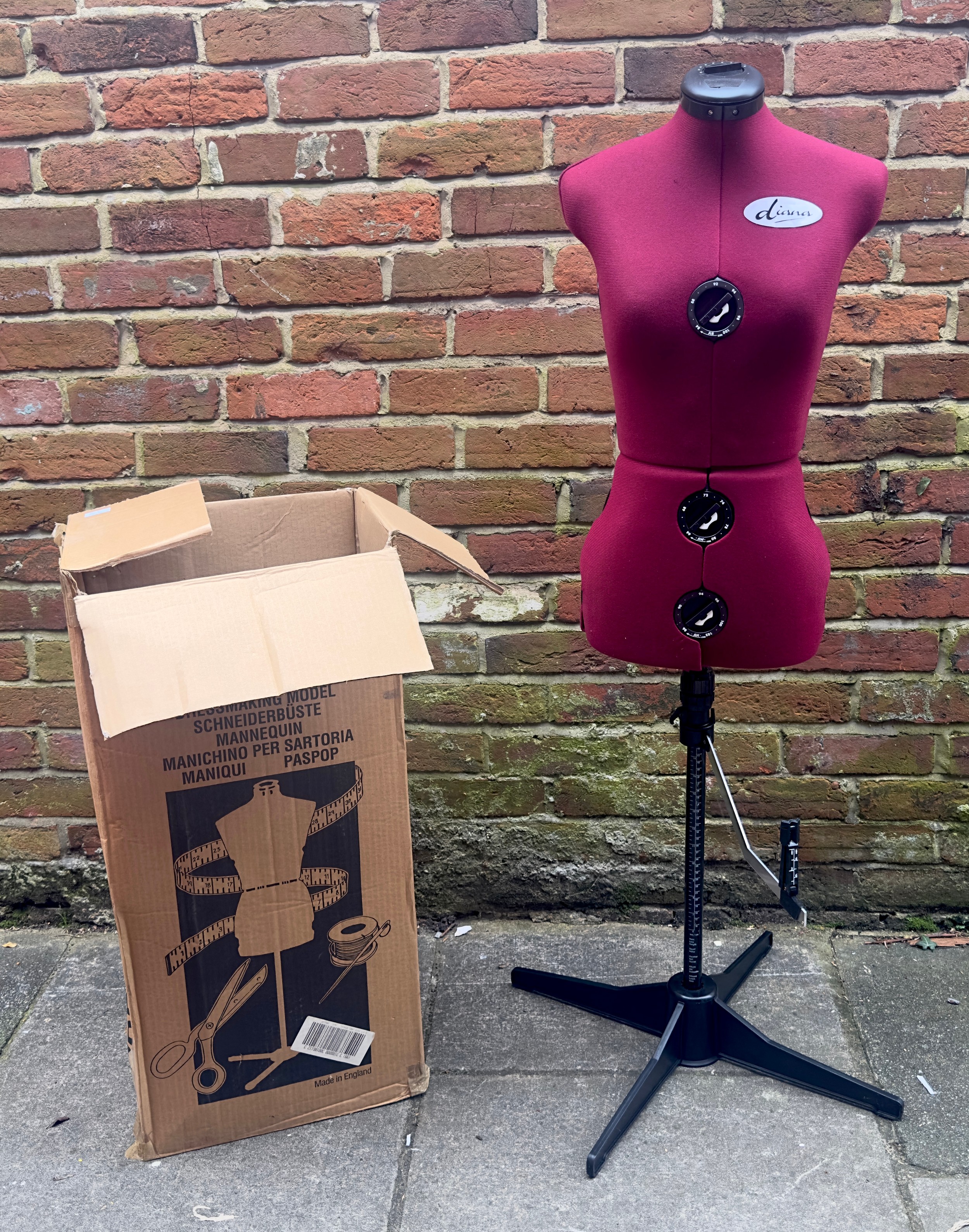 An adjustable red fabric upholstered mannequin by ‘Diana’, on base, in original box, together with a