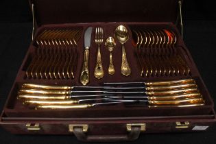 An SBS Bestecke Solingen gold-plated cutlery set in branded fitted attaché case, across two tiers