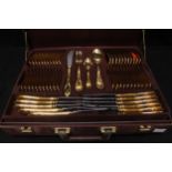 An SBS Bestecke Solingen gold-plated cutlery set in branded fitted attaché case, across two tiers