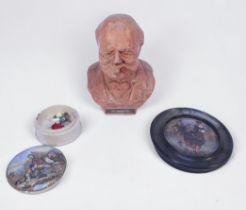 A terracotta bust of Winston Churchill smoking a cigar, with etched initials to back, 21cm tall,