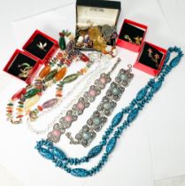 An assortment of silver and costume jewellery, including two white metal panel bracelets, various