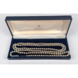 Two strings of cultured pearls, one shorter string with 9ct gold clasp, together with one longer