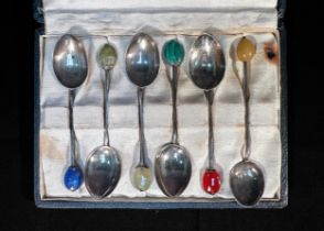 A part set of five silver coffee spoons by Liberty & Co, with hardstone finals including