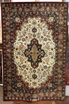 A Persian rug, probably silk and wool, central medallion to a cream field with spandrels, multi