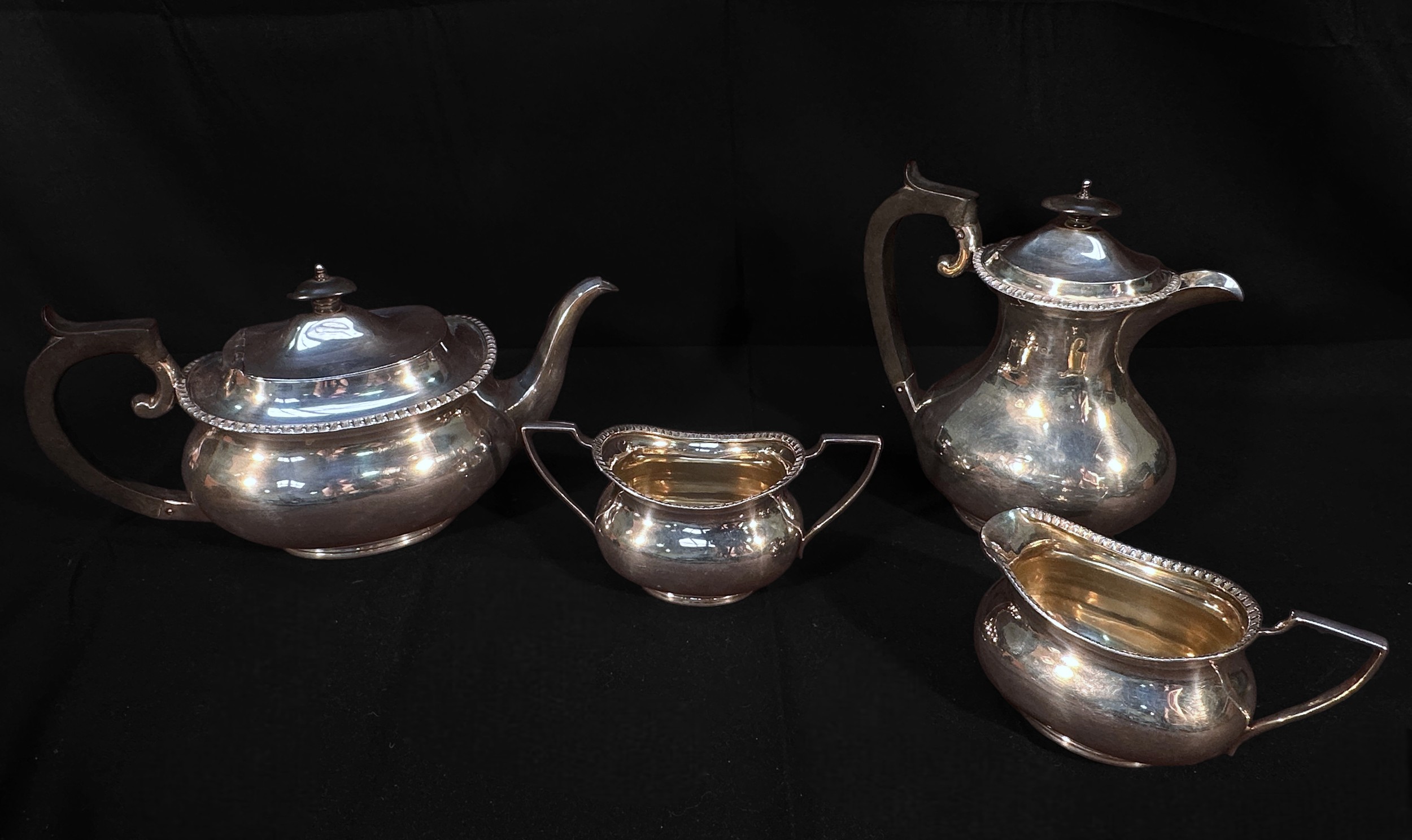 A three piece silver tea set, of compressed oval form, comprising teapot, sugar bowl and cream