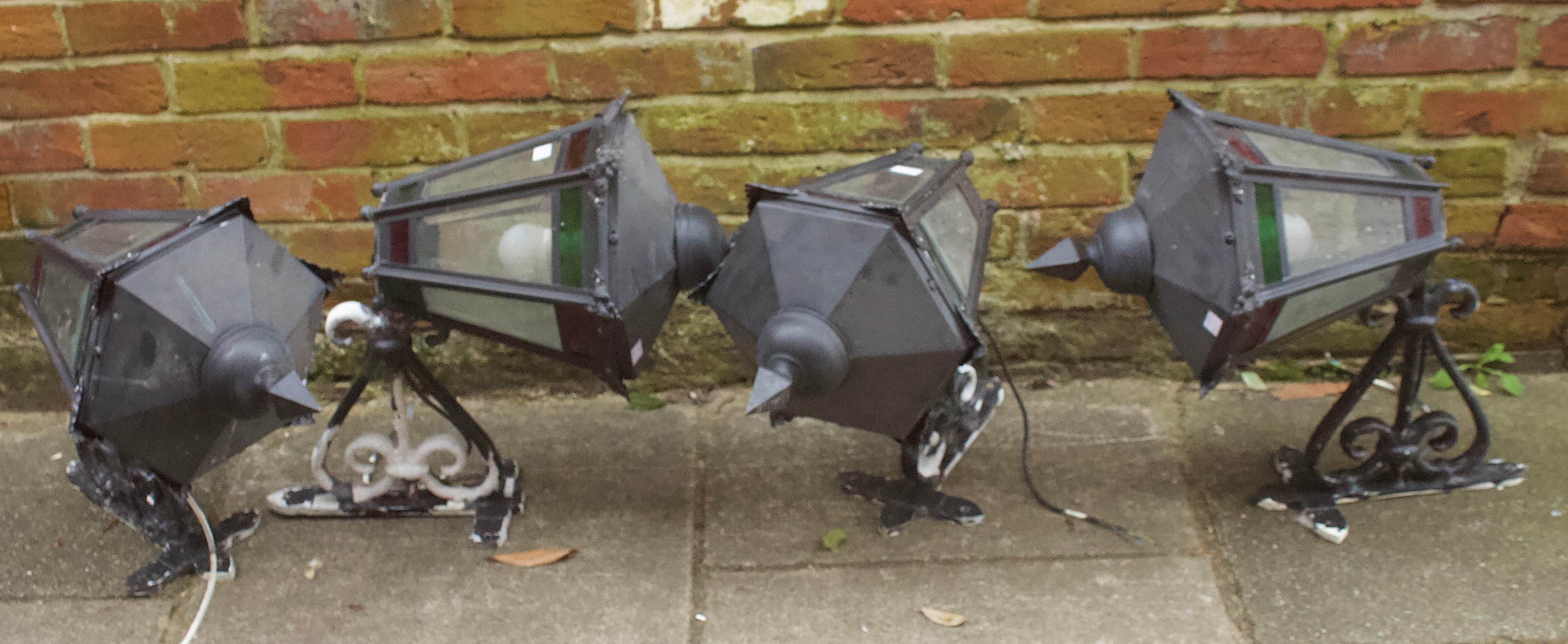 A set of four Victorian 'style' black metal electric wall lamps, each of hexagonal form with